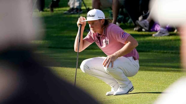 Cam Smith lines up a putt at the 2022 Masters Tournament.